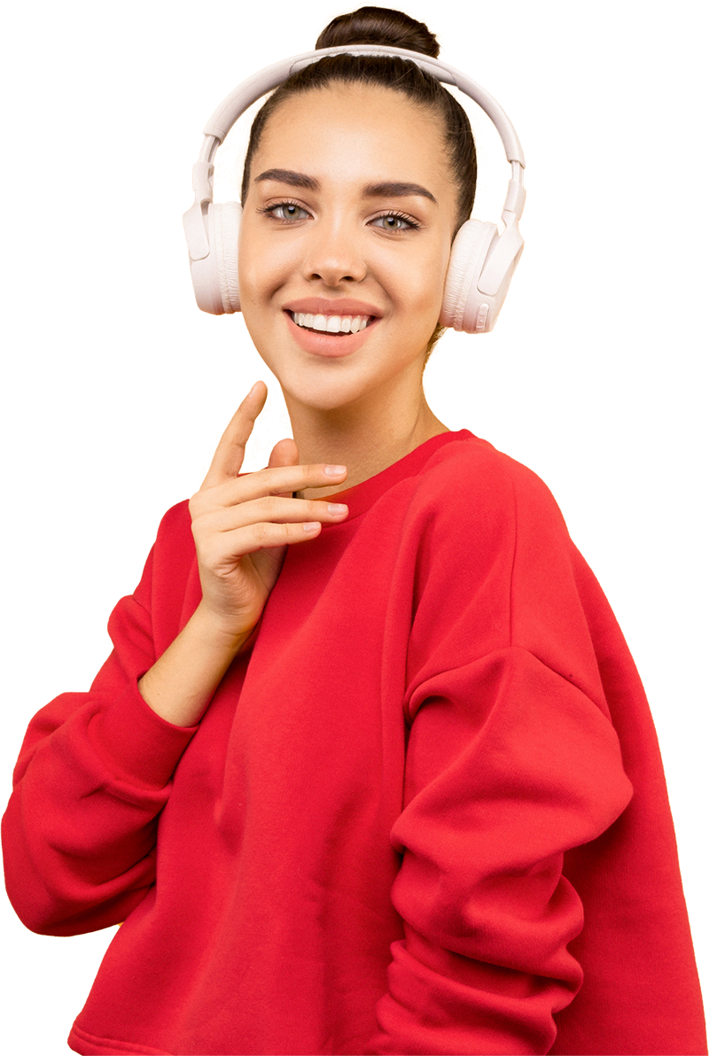 A person wearing a red sweatshirt and white headphones smiles while touching their chin, standing against a yellow background.